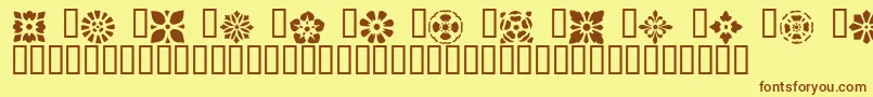 フォントVictorianDesignsOne – 茶色の文字が黄色の背景にあります。