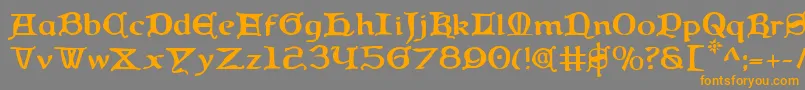フォントQueencountry – オレンジの文字は灰色の背景にあります。