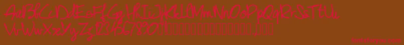 フォントPwjunescript – 赤い文字が茶色の背景にあります。