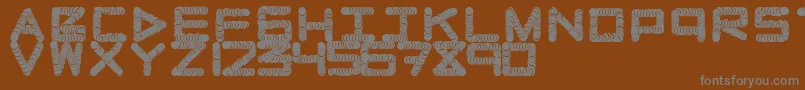 Naughtypipe Font – Gray Fonts on Brown Background