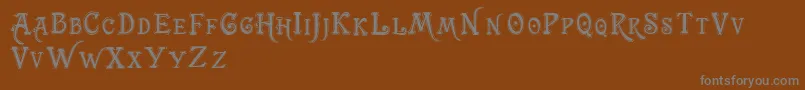 Trashbarusa-fontti – harmaat kirjasimet ruskealla taustalla