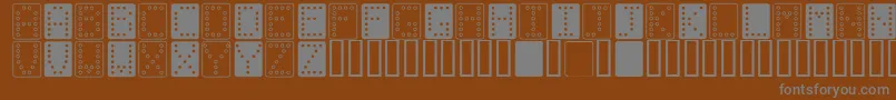 フォントDominoBred – 茶色の背景に灰色の文字