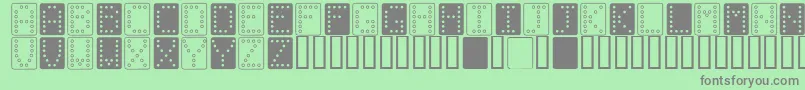 フォントDominoBred – 緑の背景に灰色の文字