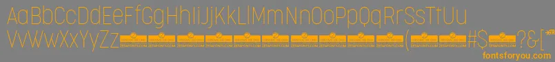 Czcionka CocogooseCondensedThinTrial – pomarańczowe czcionki na szarym tle