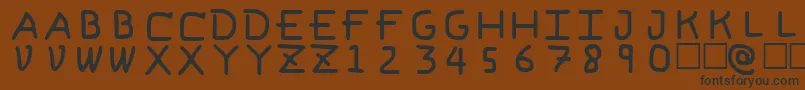 フォントPfVeryverybadfont6 – 黒い文字が茶色の背景にあります