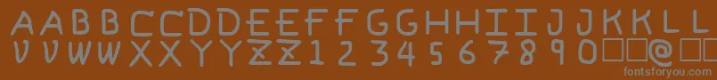 Fonte PfVeryverybadfont6 – fontes cinzas em um fundo marrom