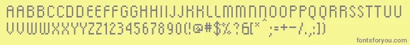 フォントDscRg – 黄色の背景に灰色の文字