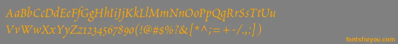 フォントPoeticastd – オレンジの文字は灰色の背景にあります。