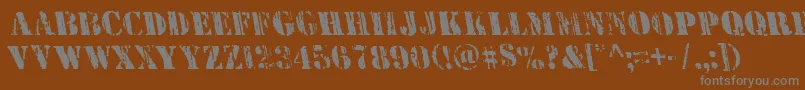 Wetworksleft-fontti – harmaat kirjasimet ruskealla taustalla