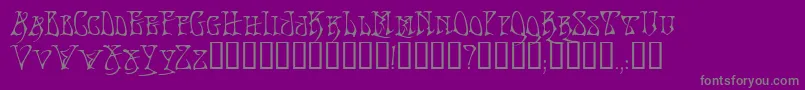 BadacidTM-fontti – harmaat kirjasimet violetilla taustalla