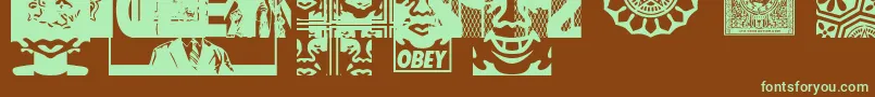 フォントObeyassortyCaps – 緑色の文字が茶色の背景にあります。