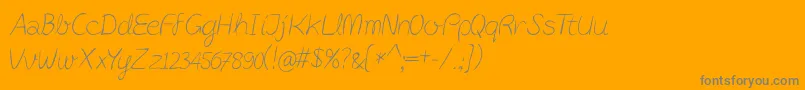 PostitPenscript-fontti – harmaat kirjasimet oranssilla taustalla