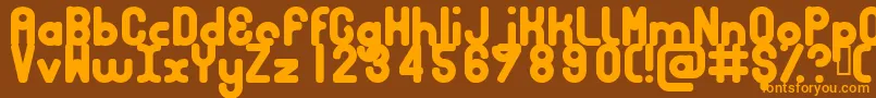 フォントBubbcb – オレンジ色の文字が茶色の背景にあります。