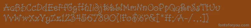 フォントDancinLetPlain.1.0 – 茶色の背景に灰色の文字