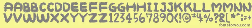 Mukokusekikitchen-Schriftart – Graue Schriften auf gelbem Hintergrund