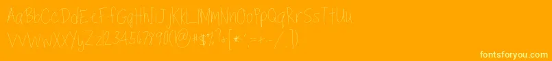 Czcionka TippytoesSkinny – żółte czcionki na pomarańczowym tle