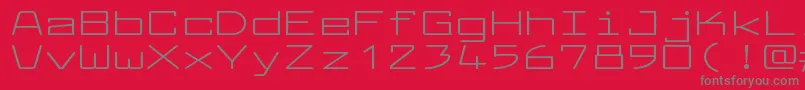 フォントLarabiefontxtRegular – 赤い背景に灰色の文字