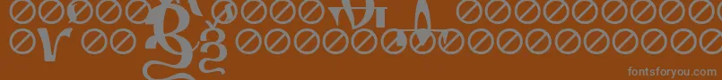 IrmologionErok-fontti – harmaat kirjasimet ruskealla taustalla