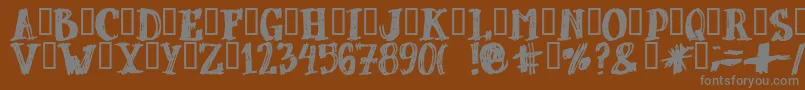 Dubbel-fontti – harmaat kirjasimet ruskealla taustalla