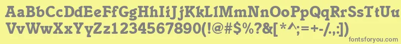 Inclinatblackssk-fontti – harmaat kirjasimet keltaisella taustalla