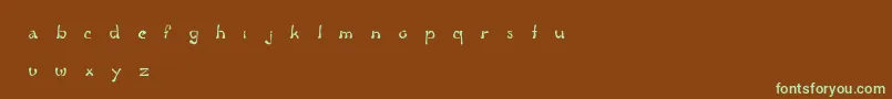 フォントFluidGroove – 緑色の文字が茶色の背景にあります。