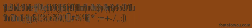 フォントDuerg – 黒い文字が茶色の背景にあります