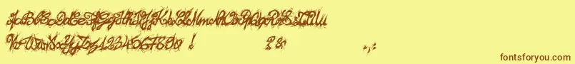 フォントEl26fontBrush2129 – 茶色の文字が黄色の背景にあります。