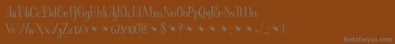 SpinnenkopDemo-fontti – harmaat kirjasimet ruskealla taustalla