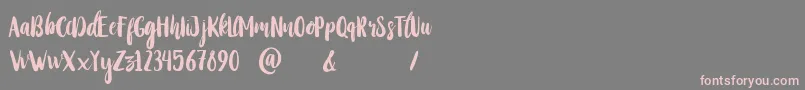 StayWildy-Schriftart – Rosa Schriften auf grauem Hintergrund