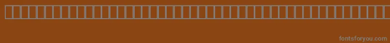 フォントMapinfoArrows – 茶色の背景に灰色の文字