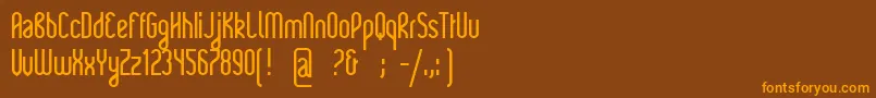 フォントRajkeys – オレンジ色の文字が茶色の背景にあります。