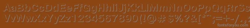 Pgs75C-fontti – harmaat kirjasimet ruskealla taustalla