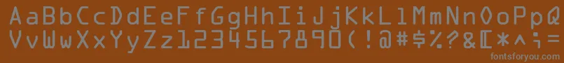OcraLtAlternate-fontti – harmaat kirjasimet ruskealla taustalla