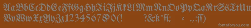 Fraktura-fontti – harmaat kirjasimet ruskealla taustalla