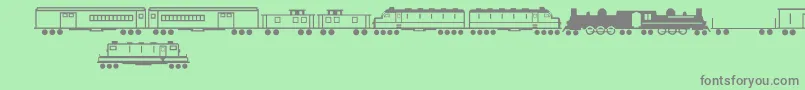 フォントTrainsRegular – 緑の背景に灰色の文字