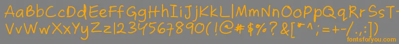 フォントZakirahscasual – オレンジの文字は灰色の背景にあります。