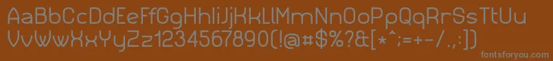 Simm023-fontti – harmaat kirjasimet ruskealla taustalla