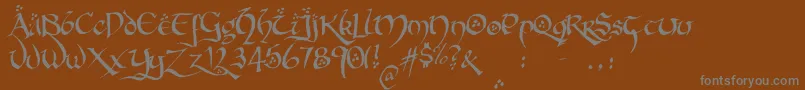 Fonte HobbitonBrushhandhobbitonBrush – fontes cinzas em um fundo marrom