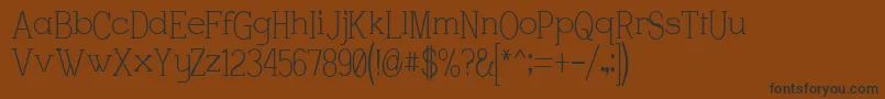 フォントCharstrwn – 黒い文字が茶色の背景にあります