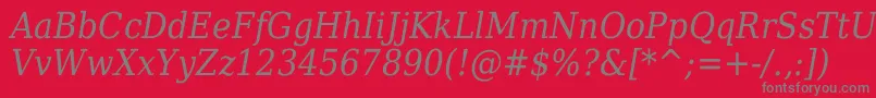 DejavuSerifItalicCondensed-fontti – harmaat kirjasimet punaisella taustalla