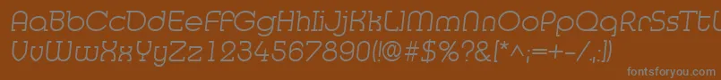 MedflyLight-fontti – harmaat kirjasimet ruskealla taustalla