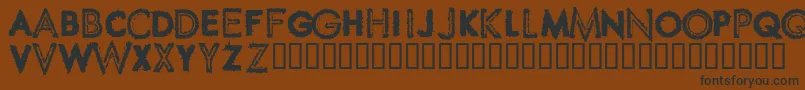 フォントSpikeCrumbSwollen – 黒い文字が茶色の背景にあります