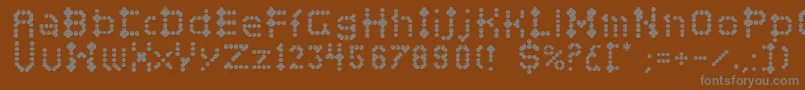 Campcraftbasic-fontti – harmaat kirjasimet ruskealla taustalla