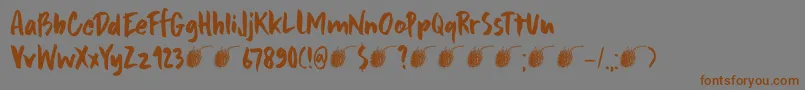 フォントDkFramboisier – 茶色の文字が灰色の背景にあります。