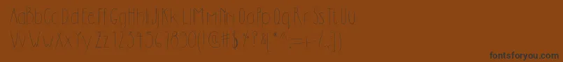 Dilemhandwritten-fontti – mustat fontit ruskealla taustalla