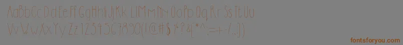 フォントDilemhandwritten – 茶色の文字が灰色の背景にあります。