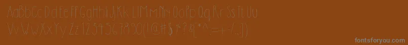 フォントDilemhandwritten – 茶色の背景に灰色の文字