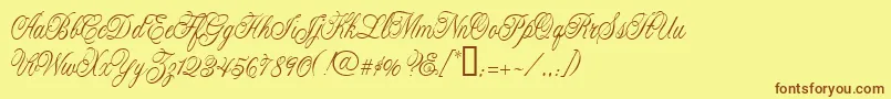 フォントCacLaskoCondensed – 茶色の文字が黄色の背景にあります。