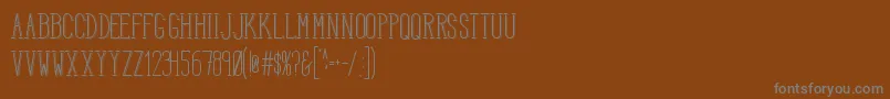 HbmSerenitySound-fontti – harmaat kirjasimet ruskealla taustalla
