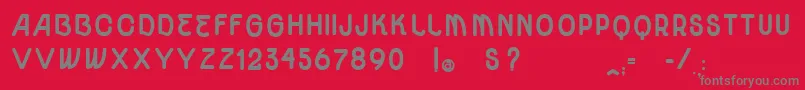 Fonte VtksUnidadeUltraBold – fontes cinzas em um fundo vermelho